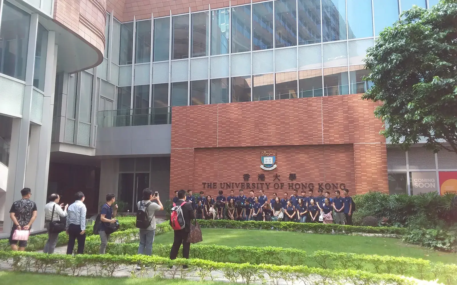 Вывеска The University of Hong Kong и сад у Centennial Building в кампусе HKU